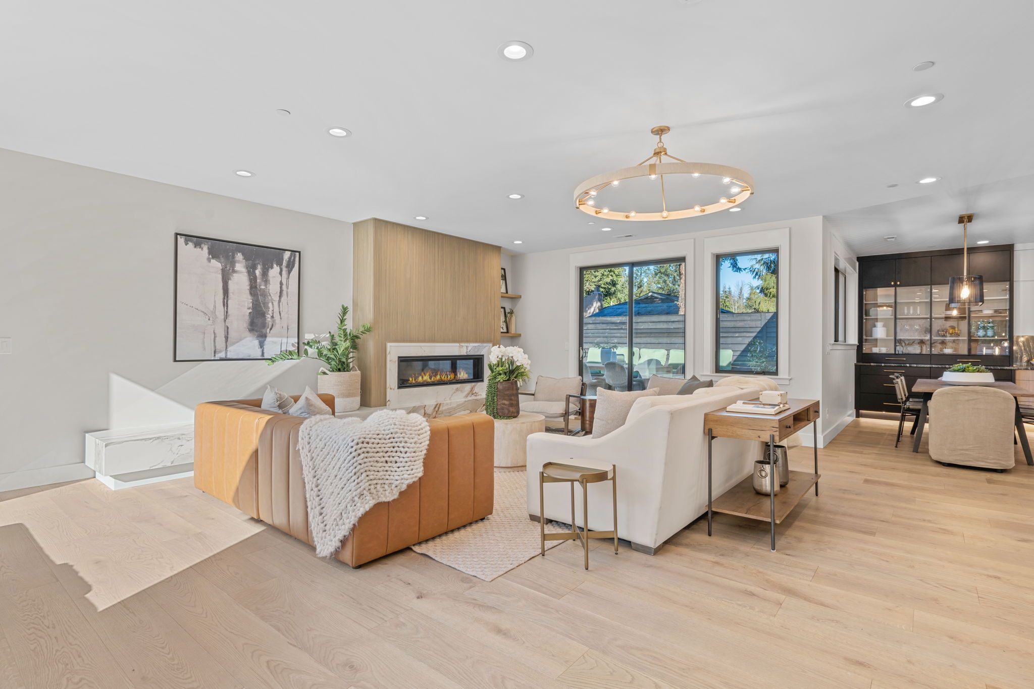 Kirkland living room remodel with marble fireplace surround and statement lighting by Rayna Vogel Interior Design